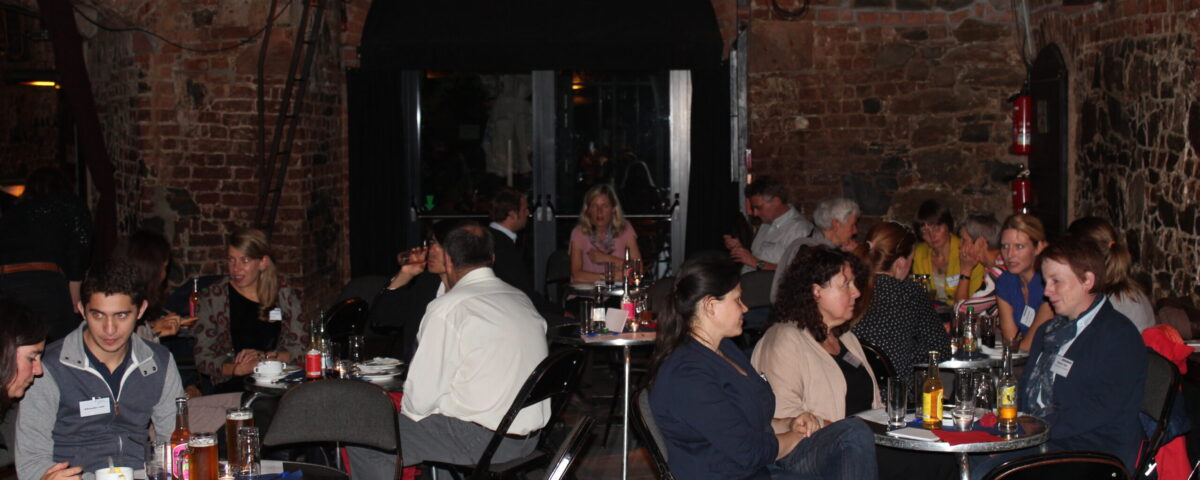 Participants of the network meeting sit at different table circles on one evening and talk to each other