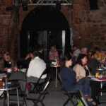 Participants of the network meeting sit at different table circles on one evening and talk to each other