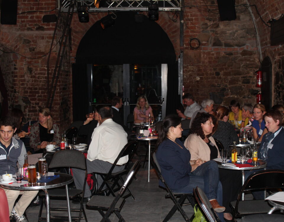 Participants of the network meeting sit at different table circles on one evening and talk to each other